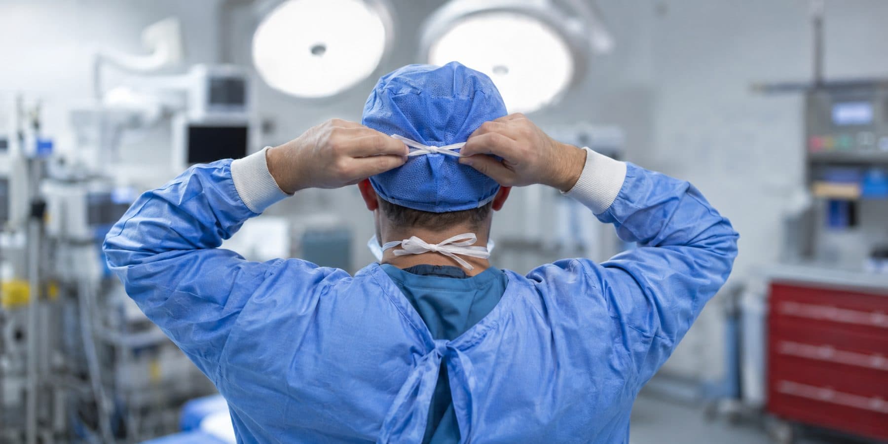 Surgeons working under operating-room lights
